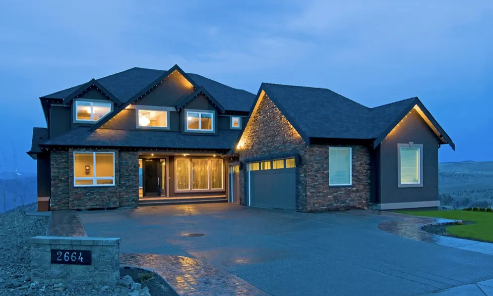 Telford custom home at dusk overlooking the water — built by Dev Dheenshaw Construction